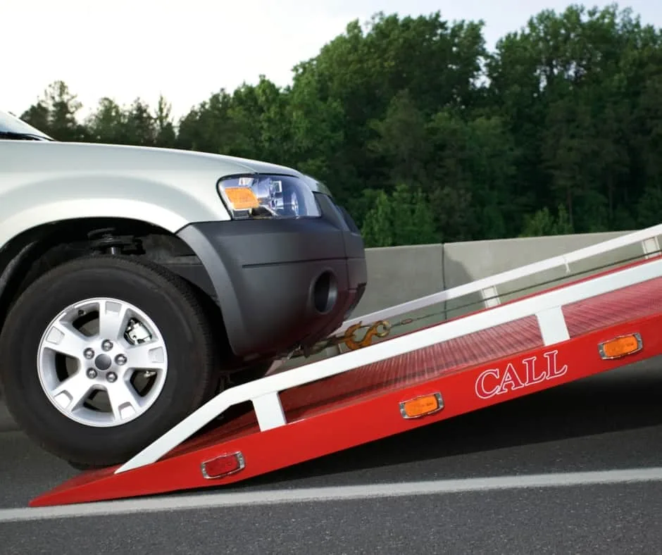 Kansas City tow truck loading a vehicle on a residential street